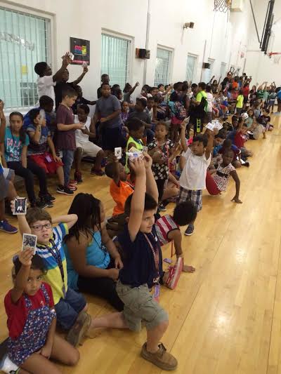 Members of the Houston Boys and Girls Club showing off their favorite sports cards.